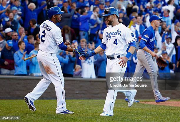 Alex Gordon of the Kansas City Royals celebrates with Alcides Escobar of the Kansas City Royals after scoring a run in the seventh inning against the...
