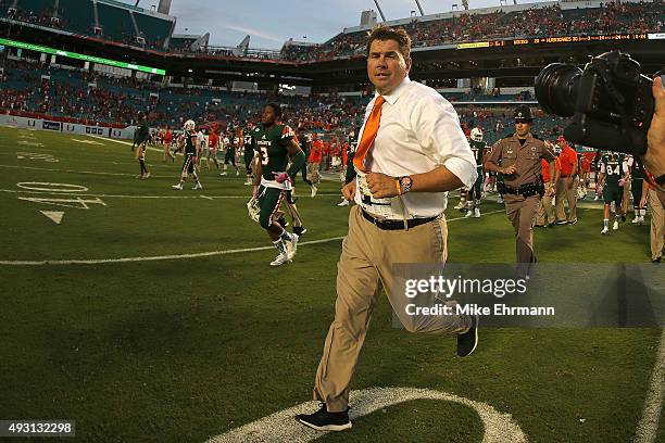 Head coach Al Golden of the Miami Hurricanes runs off the field following a game against the Virginia Tech Hokies at Sun Life Stadium on October 17,...