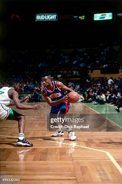 Lindsey Hunter of the Detroit Pistons looks to drive against the Boston Celtics during a game played circa 1994 at the Boston Garden in Boston,...