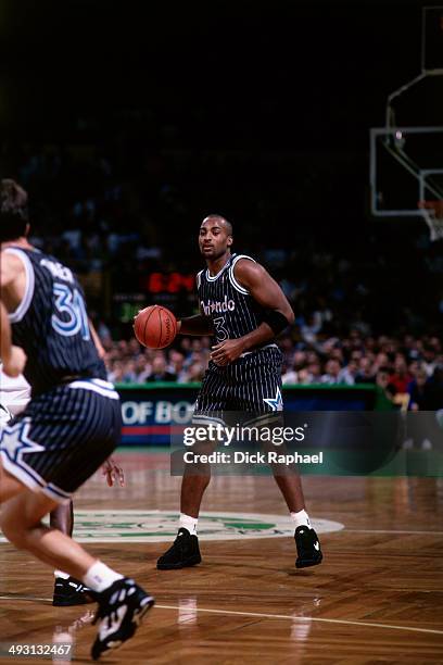 Dennis Scott of the Orlando Magic looks to pass against the Boston Celtics during a game played circa 1994 at the Boston Garden in Boston,...