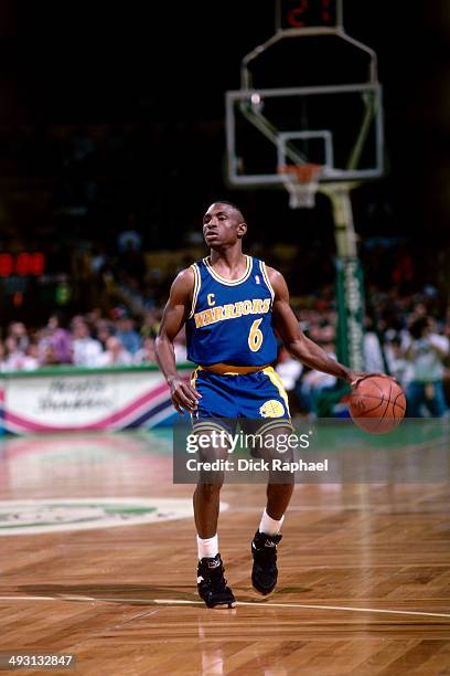 Avery Johnson of the Golden State Warriors dribbles during a game against the Boston Celtics played circa 1994 at the Boston Garden in Boston,...