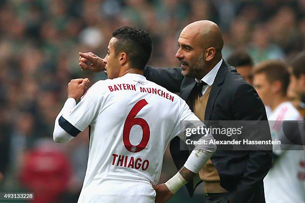 Josep Guardiola, head coach of Muenchen reacts to his player Thiago during the Bundesliga match between SV Werder Bremen and FC Bayern Muenchen at...