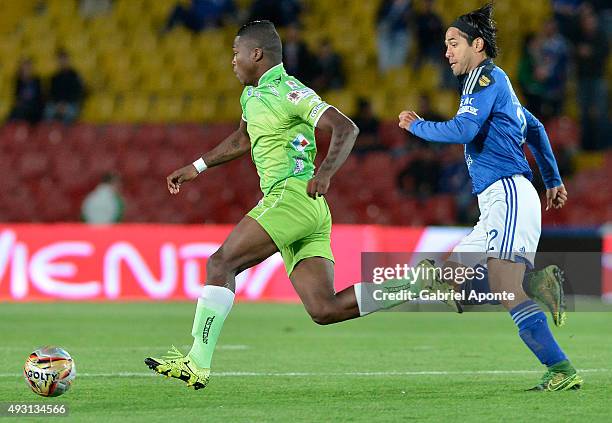 Fabian Vargas of Millonarios struggles for the ball with William Palacios of Jaguares FC during a match between Millonarios and Jaguares FC as part...