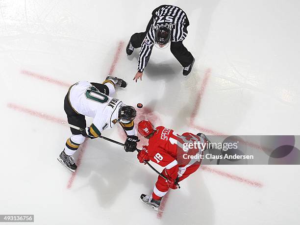 Blake Speers of the Sault Greyhounds takes a faceoff against Christian Dvorak of the London Knights during an OHL game at Budweiser Gardens on...