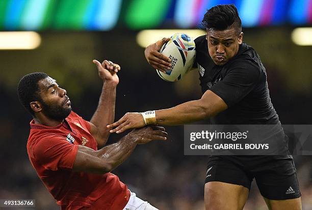 New Zealand's wing Julian Savea pushes France's wing Noa Nakaitaci as he runs to score his second and his team's fourth try during a quarter final...