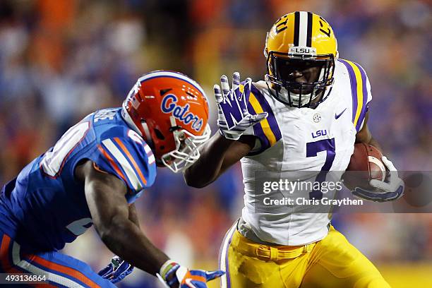 Leonard Fournette of the LSU Tigers runs for a first down past Marcus Maye of the Florida Gators at Tiger Stadium on October 17, 2015 in Baton Rouge,...