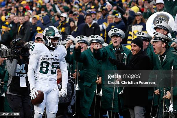 Wide receiver Macgarrett Kings Jr. #85 of the Michigan State Spartans reacts after scoring a 30 yard touchdown reception against the Michigan...