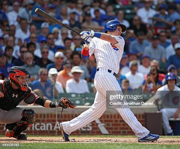 Chris Coghlan of the Chicago Cubs hits a run-scoring single in the 1st inning against the San Francisco Giants at Wrigley Field on August 7, 2015 in...