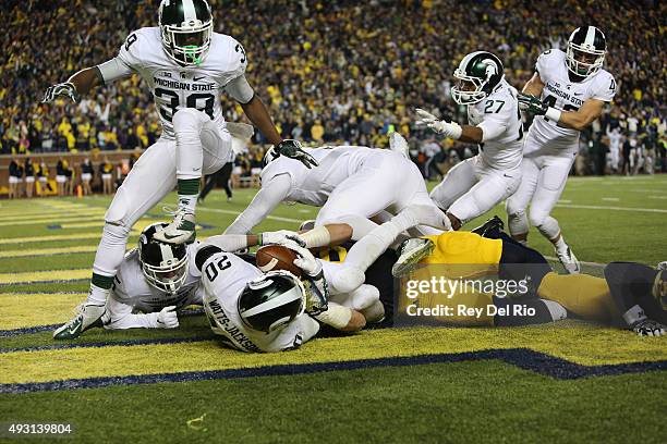 The Michigan State Spartans celebrate in the endzone after defensive back Jalen Watts-Jackson scored the game winning touchdown against the Michigan...