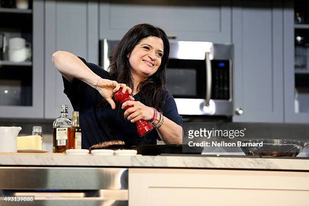 Chef Alex Guarnaschelli prepares food on stage during the Grand Tasting presented by ShopRite featuring Samsung culinary demonstrations presented by...