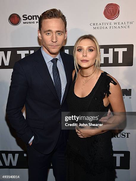 Actor Tom Hiddleston, left, and actress Elizabeth Olsen attend the premiere of "I Saw The Light" at The Belcourt Theatre on October 17, 2015 in...