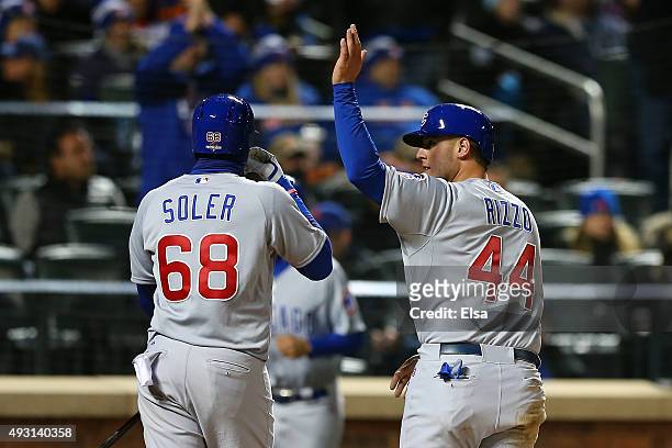 Anthony Rizzo of the Chicago Cubs celebrates with teammates Jorge Soler after scoring off of Starlin Castro's double to center field in the fifth...
