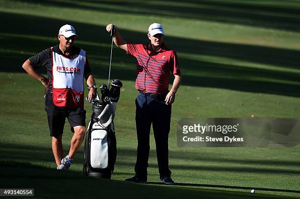 Justin Rose of England pulls a club from his bag on the 16th hole during the third round of the Frys.com Open on October 17, 2015 at the North Course...