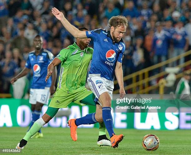 Federico Insua of Millonarios struggles for the ball with Elkin Barrera player of Jaguares FC during a match between Millonarios and Jaguares FC as...