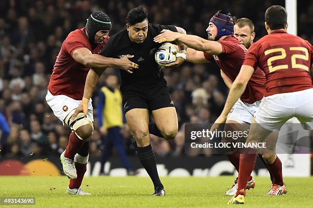 New Zealand's wing Julian Savea pushes through the French defence during the quarter final match of the 2015 Rugby World Cup between New Zealand and...