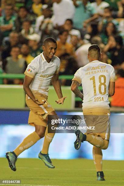 Pumas' Ismael Sosa celebrates with teammate Fidel Martinez after scoring a goal against Leon during their Mexican Apertura tournament football match...