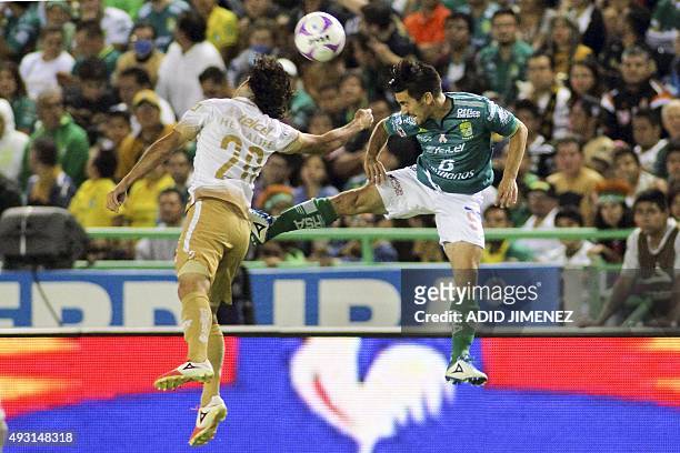 Fernando Navarro of Leon jumps for ball with Matias Britos of Pumas during their Mexican Apertura tournament football match at the Nou Camp stadium...