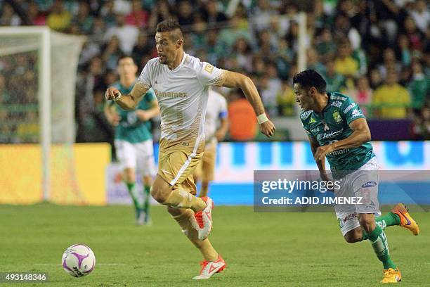 Jose Juan Vazquez of Leon vies for ball with Dante Lopez of Pumas during their Mexican Apertura tournament football match at the Nou Camp stadium on...