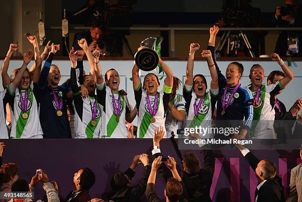 Captain Nadine Kessler of VfL Wolfsburg lifts the trophy in celebration alongsaide team mates after the UEFA Women's Champions Final match between...