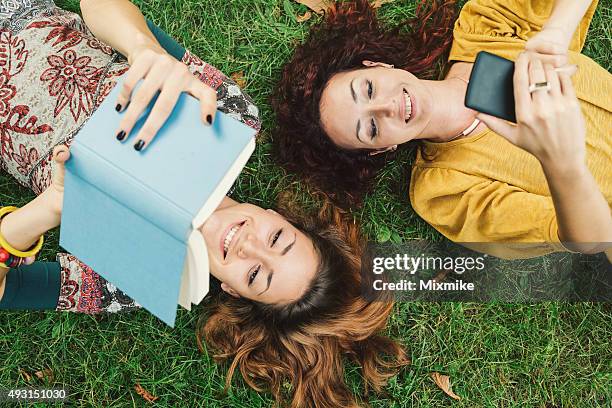 leisure time - read book outside young woman stock pictures, royalty-free photos & images