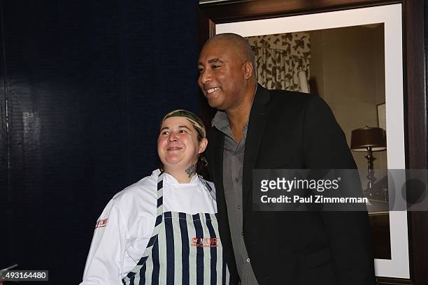 Former baseball player Bernie Williams poses for a photo with a participant at Delta Air Lines Presents New York Yankees Pinstripe Brunch Hosted By...