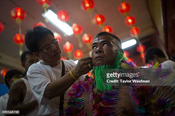 Devotee has decorative needle piercings placed all over his body while in a trane-like state at Bang Neow Shrine on October 18, 2015 in Phuket,...