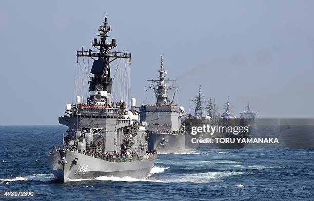 Japan's Maritime Self-Defense Force escort ship Kurama sails with other ships during a fleet review off Sagami Bay, Kanagawa prefecture, on October...