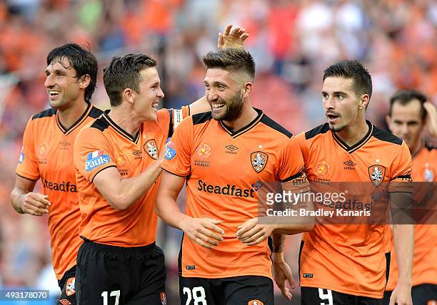 Brandon Borrello of the Roar is congratulated by team mates Matt McKay and Jamie Maclaren after scoring a goal during the round two A-League match...