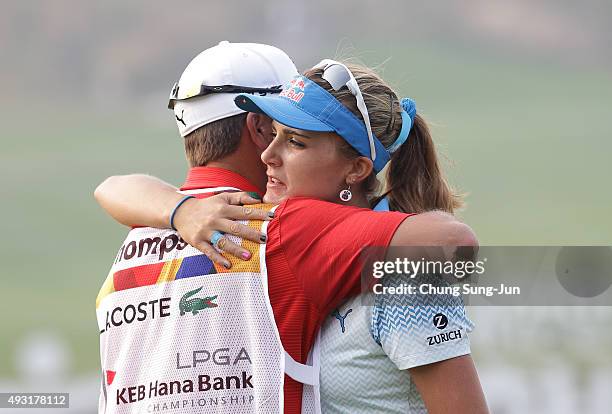 Lexi Thompson of United States hugs with caddie after a putt on the 18th green during round four of the LPGA KEB HanaBank on October 18, 2015 in...