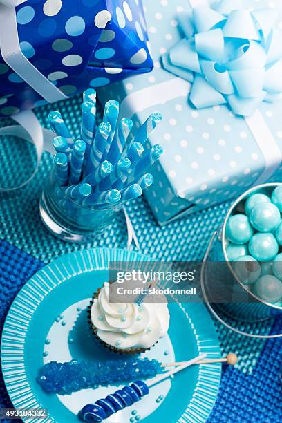 birthday boy blue party with candy presents and cupcakes - 1st birthday cake stock pictures, royalty-free photos & images