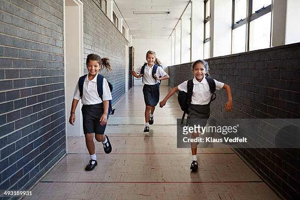 schoolgirl running in the corridors - uniform imagens e fotografias de stock