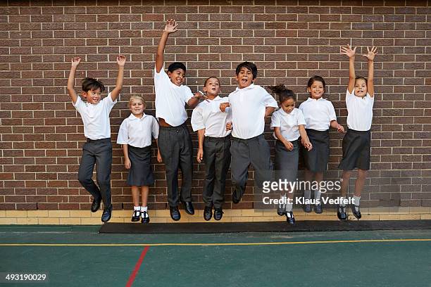 groupshot of classmates jumping - children only stock pictures, royalty-free photos & images