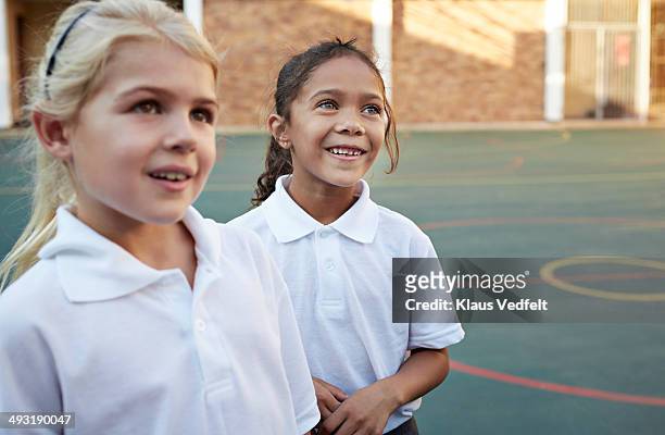 portrait of schoolgirls in schoolyard - nur mädchen stock-fotos und bilder