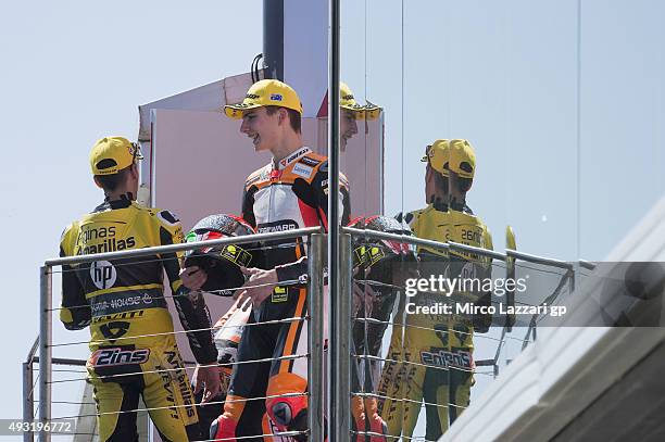 Alex Rins of Spain and Pagina Amarillas HP40 and Lorenzo Baldassarri of Italy and Forward Racing celebrate on the podium at the end of the Moto2 race...