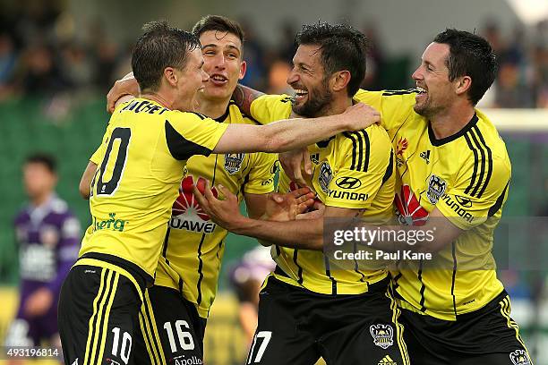 Vince Lia of the Phoenix is congratulated by team mates after scoring a goal during the round two A-League match between the Perth Glory and...