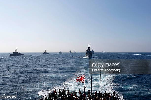 Japan's Maritime Self-Defense Force destroyer ship Kurama, right, leads a troop of vessels during a review at Sagami Bay, off Yokosuka, Kanagawa...
