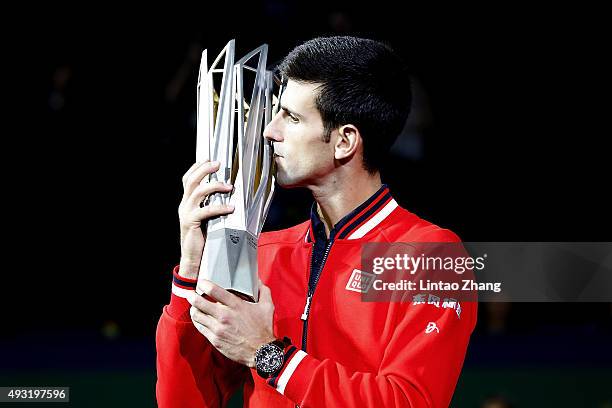 Novak Djokovic of Serbia poses with the winner's trophy after defeating Jo-Wilfried Tsonga of France during the men's singles final match of the...