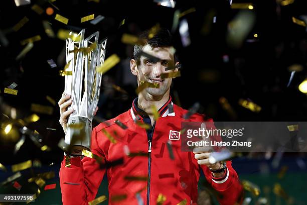 Novak Djokovic of Serbia poses with the winner's trophy after defeating Jo-Wilfried Tsonga of France during the men's singles final match of the...