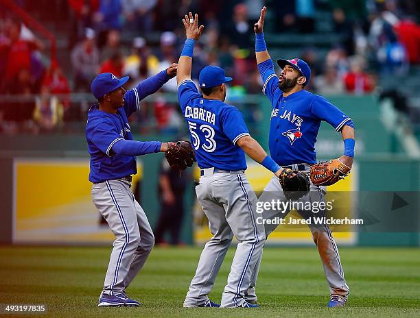 Jose Bautista, Melky Cabrera, and Anthony Gose of the Toronto Blue Jays celebrate their win and sweep of the Boston Red Sox during the game at Fenway...