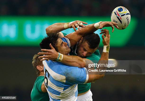 Robbie Henshaw of Ireland jumps for the ball with Pablo Matera of Argentina during the 2015 Rugby World Cup Quarter Final match between Ireland and...