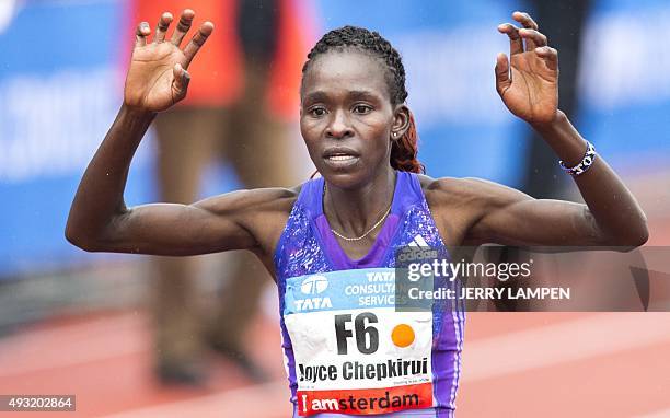 Kenya's Joyce Chepkirui celebrates after crossing the finish line to win the Amsterdam Marathon 2015 in Amsterdam, The Netherlands, on October 18,...