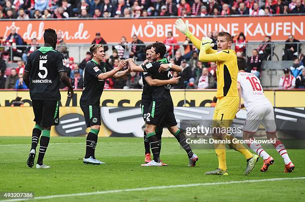 Leon Andreasen of Hannover 96 celebrates with team mates as he scores the opening goal during the Bundesliga match between 1. FC Koeln and Hannover...