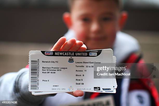 Young Newcastle fan shows off his match ticket during the Barclays Premier League match between Newcastle United and Norwich City at St James Park on...