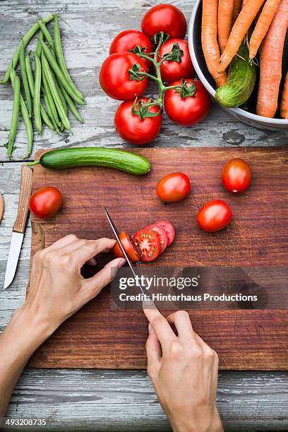 cutting fresh vegetable on vintage garden table - chopping board from above stock pictures, royalty-free photos & images