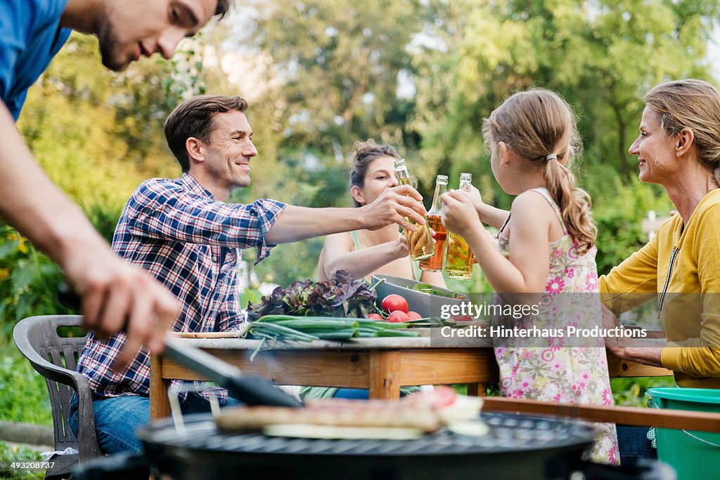 Family At Barbeque Event In Backyard