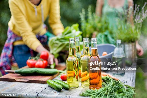 beverages and vegetable on garden table - seizoen stockfoto's en -beelden