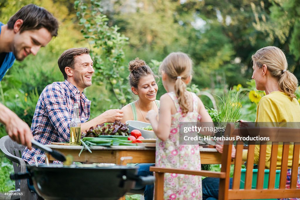 Family At Barbeque In A Garden