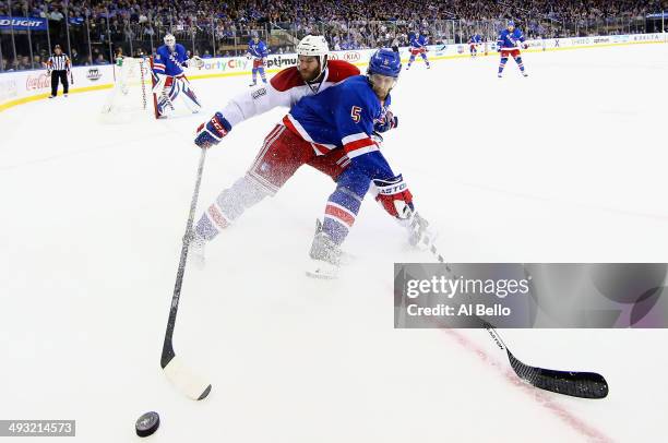 Dan Girardi of the New York Rangers and Brandon Prust of the Montreal Canadiens battle for the puck along the boards in Game Three of the Eastern...