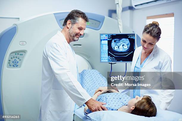 doctors preparing patient for ct scan in hospital - mri stock-fotos und bilder