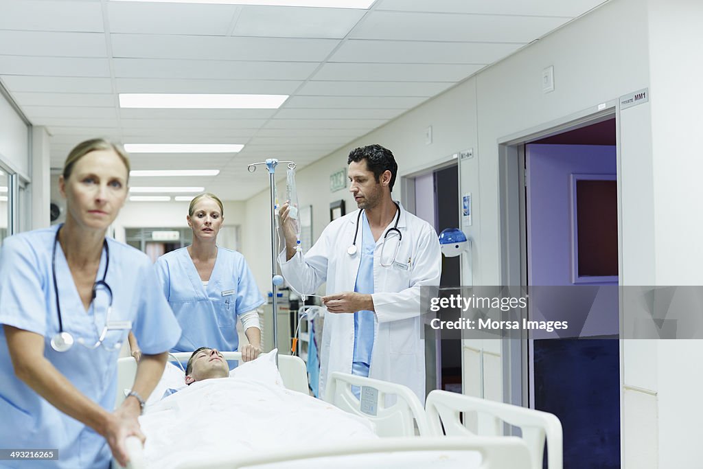 Workers Rushing Healthcare Workers Rushing Patient In Corridor High-Res Stock Photo ...